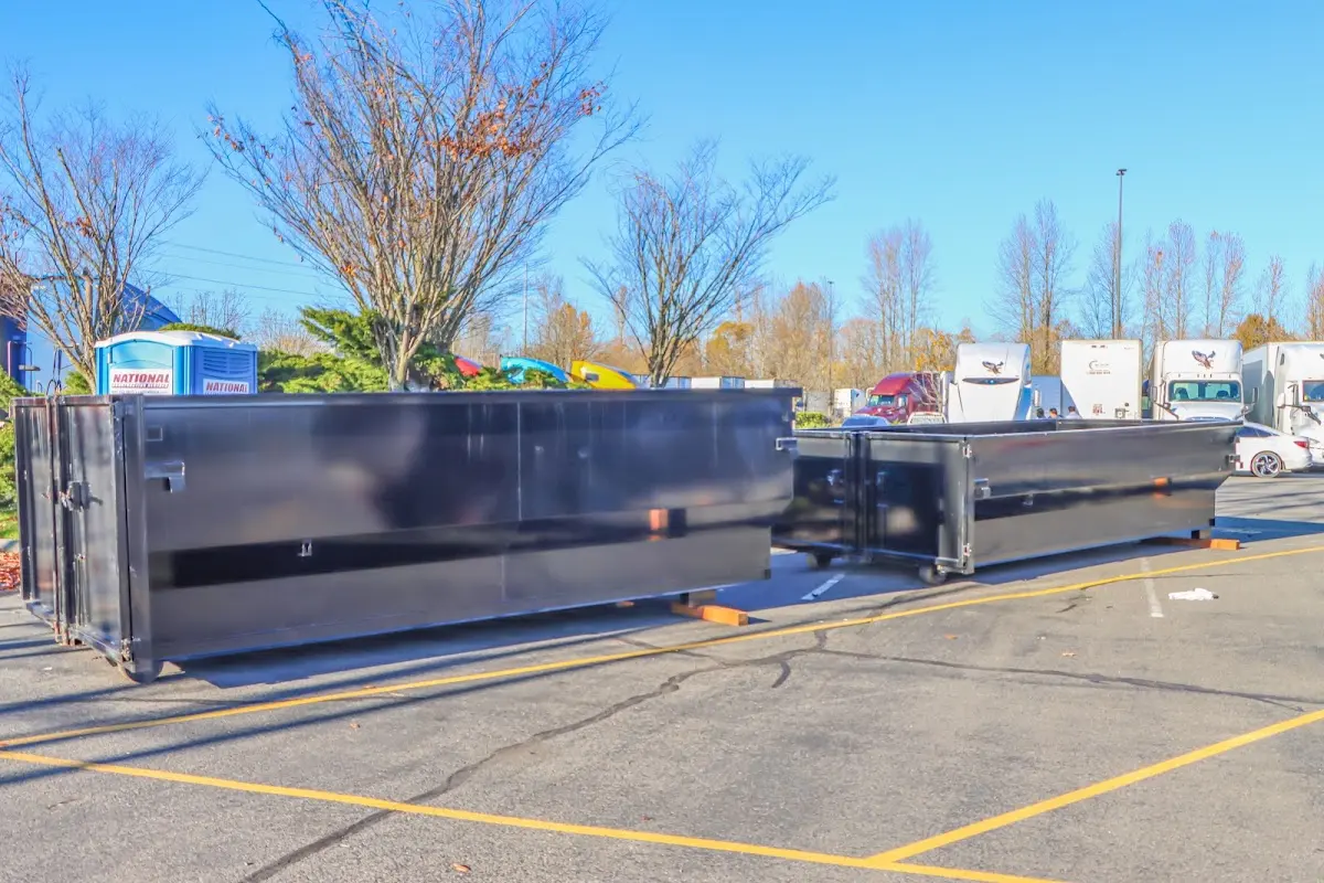 Professional dumpster rental service with roll-off container on residential driveway in Oneonta